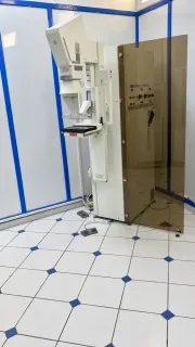 Mammography machine with a protective screen in the examination room.